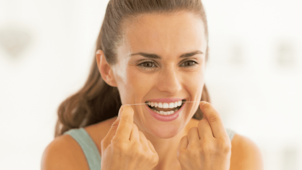 How does someone brush and floss with dental veneers
